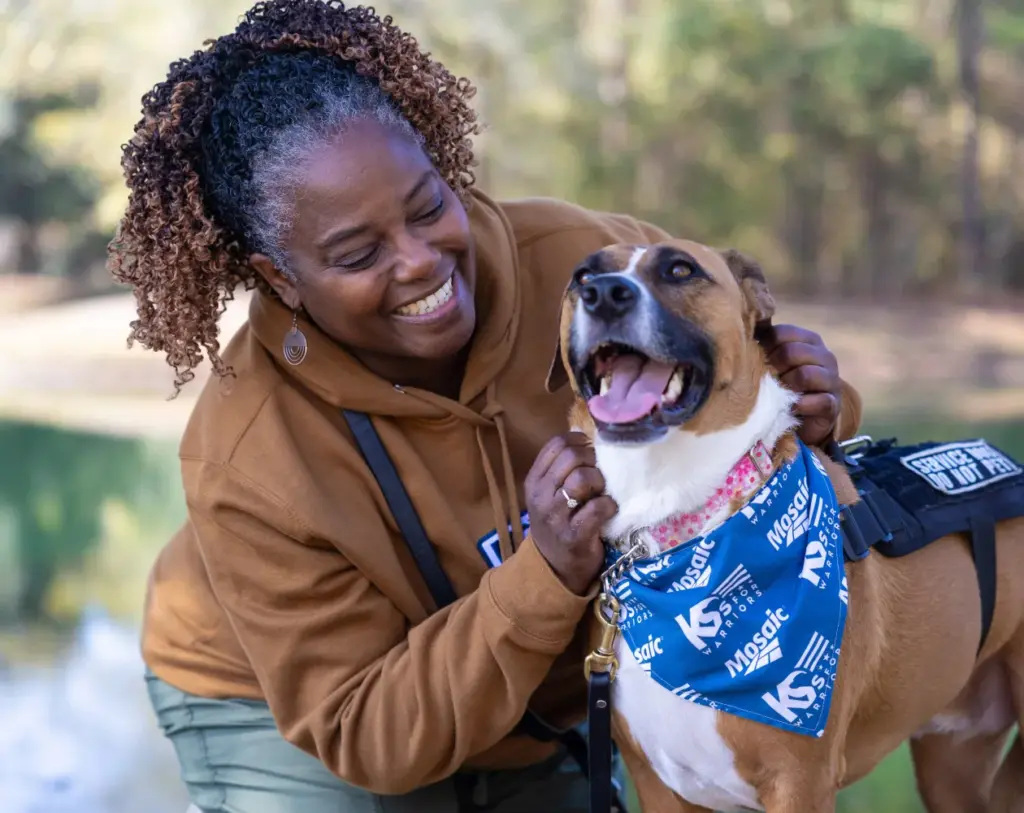 Woman with her dog wearing a USA flag bandana