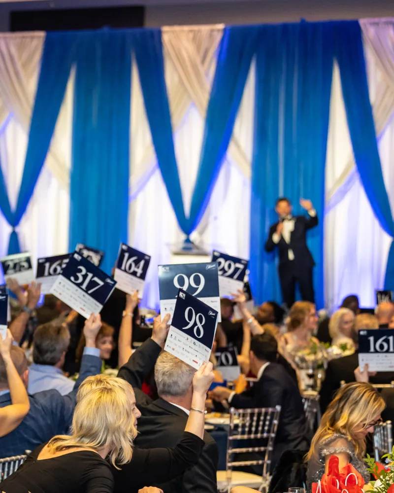 Auctioning at a corporate sponsorship event