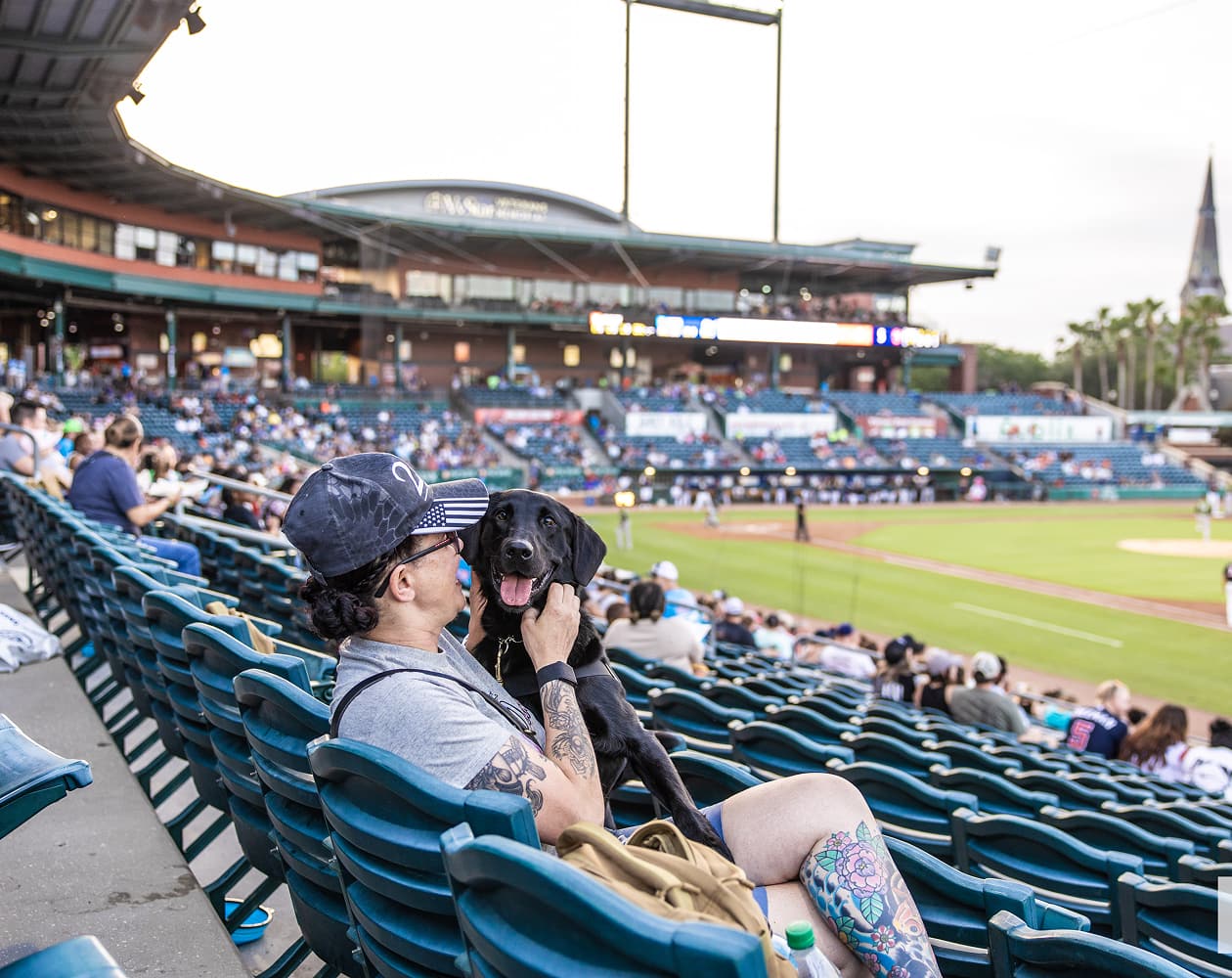 Woman at a sports arena with dog